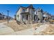 Modern two-story townhome featuring varied siding and a partially fenced front yard; landscaping is in progress at 458 Millwall Cir, Castle Pines, CO 80108