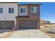 Modern townhome featuring a driveway, two car garage and mixed siding exterior at 458 Millwall Cir, Castle Pines, CO 80108