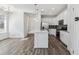 Bright kitchen with an island, stainless steel appliances, and wood-look flooring at 458 Millwall Cir, Castle Pines, CO 80108