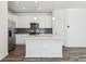 Modern kitchen with stainless steel appliances, a center island, and grey tile backsplash at 458 Millwall Cir, Castle Pines, CO 80108