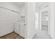 Bright laundry room featuring a modern white washer and dryer near hallway at 458 Millwall Cir, Castle Pines, CO 80108