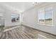 Light filled living room with hardwood floors and large windows that provide views of the neighborhood at 458 Millwall Cir, Castle Pines, CO 80108