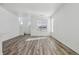 Bright, spacious living room featuring hardwood floors, large windows, and a view of the stairway at 458 Millwall Cir, Castle Pines, CO 80108