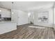 Bright, spacious living room featuring hardwood floors, large windows, and a view of the stairway at 458 Millwall Cir, Castle Pines, CO 80108