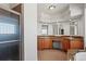 Primary bathroom with dual sinks, granite countertops, and glass-enclosed shower at 51 W 6Th Pl, Byers, CO 80103