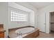 Bathroom featuring a soaking tub, glass block window and tile surround at 51 W 6Th Pl, Byers, CO 80103