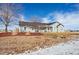 Exterior view of the home, featuring a well-maintained lawn and landscaping at 51 W 6Th Pl, Byers, CO 80103