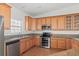 Modern kitchen features stainless steel appliances, wood cabinetry and granite countertops at 51 W 6Th Pl, Byers, CO 80103