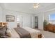 Bright main bedroom featuring a walk-in closet, dresser, and ensuite bathroom at 51 W 6Th Pl, Byers, CO 80103