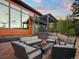 Cozy backyard seating area with a modern fire pit and comfortable outdoor furniture at 34089 Woodland Dr, Evergreen, CO 80439