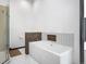 Modern bathroom showcasing a soaking tub with tiled accent wall and glass-enclosed shower at 34089 Woodland Dr, Evergreen, CO 80439