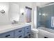 Charming bathroom featuring blue vanity, stylish mirror, and glass-enclosed shower with blue tile at 34089 Woodland Dr, Evergreen, CO 80439