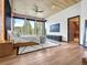 Spacious bedroom features expansive windows with scenic views, modern furniture, and a ceiling fan at 34089 Woodland Dr, Evergreen, CO 80439