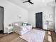 Bright bedroom with hardwood floors, daybed, ceiling fan, and modern decor accents at 34089 Woodland Dr, Evergreen, CO 80439