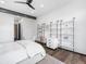 Bright bedroom featuring hardwood floors, modern decor, white shelves, and a ceiling fan at 34089 Woodland Dr, Evergreen, CO 80439