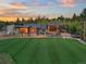 Expansive backyard with lush lawn complements the modern home's design and outdoor space at 34089 Woodland Dr, Evergreen, CO 80439