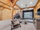 Garage featuring golf simulator, sitting area, and vehicle at 34089 Woodland Dr, Evergreen, CO 80439