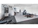 Spacious home gym with modern equipment, including weight machines and exercise bikes at 34089 Woodland Dr, Evergreen, CO 80439