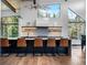 Contemporary kitchen featuring an island with bar seating and stylish lighting at 34089 Woodland Dr, Evergreen, CO 80439