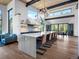 Modern kitchen with quartz countertop island, hardwood floors, and stainless steel appliances at 34089 Woodland Dr, Evergreen, CO 80439