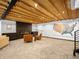 Stylish living room featuring exposed wood ceiling, modern fireplace, and comfortable seating area at 34089 Woodland Dr, Evergreen, CO 80439