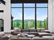 Bright living room with large windows showcasing scenic mountain views at 34089 Woodland Dr, Evergreen, CO 80439