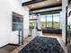 Bright open-concept living room with hardwood floors, mountain view, and modern staircase at 34089 Woodland Dr, Evergreen, CO 80439