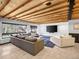 Modern living room featuring exposed wood ceiling, gray sectional sofa, and large window with view at 34089 Woodland Dr, Evergreen, CO 80439