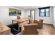 Comfortable office space features a wooden desk, plush chairs, and a window with a view at 34089 Woodland Dr, Evergreen, CO 80439
