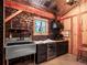 Small room featuring a sink, countertop space, beverage fridge, and custom cabinets at 34089 Woodland Dr, Evergreen, CO 80439