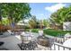 Inviting backyard patio with a dining table, comfortable seating, and a beautifully landscaped yard at 5167 S Pearl St, Littleton, CO 80121