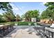 Landscaped backyard featuring a concrete patio, outdoor seating, a well-maintained lawn, and a storage shed at 5167 S Pearl St, Littleton, CO 80121
