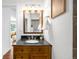 Bathroom with wood cabinet and dark granite countertop at 5167 S Pearl St, Littleton, CO 80121
