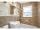 Tiled bathroom features a shower-tub combo and vanity with classic fixtures at 5167 S Pearl St, Littleton, CO 80121