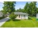 Charming home with a well-manicured front yard, mature trees, and a welcoming entrance at 5167 S Pearl St, Littleton, CO 80121