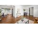 Open-concept living area with hardwood floors connecting to the dining space at 5167 S Pearl St, Littleton, CO 80121
