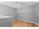 A well lit bedroom with hardwood floors and ceiling fan at 14300 Waterside Ln # E3, Broomfield, CO 80023