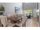 Open-concept dining area adjacent to living room with elegant table set and high ceilings at 14300 Waterside Ln # E3, Broomfield, CO 80023