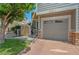 A charming townhome featuring a one car garage and lush green landscaping at 14300 Waterside Ln # E3, Broomfield, CO 80023
