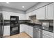 Modern kitchen featuring sleek black appliances, updated countertops, and ample cabinet space at 14300 Waterside Ln # E3, Broomfield, CO 80023