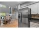 View of open layout of kitchen, dining area, and living space with large stainless steel refrigerator at 14300 Waterside Ln # E3, Broomfield, CO 80023