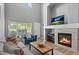 Elegant living room with a cozy fireplace, plush seating, and an abundance of natural light at 14300 Waterside Ln # E3, Broomfield, CO 80023