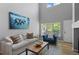 Bright living room with high ceilings, comfortable seating, and an eye-catching piece of art at 14300 Waterside Ln # E3, Broomfield, CO 80023