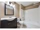 Full bathroom featuring a modern vanity, tiled shower-tub combo, and neutral wall color at 12037 E Harvard Ave # 104, Aurora, CO 80014