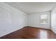 Clean bedroom with hardwood floors, white walls, a closet, and natural light from a window at 12037 E Harvard Ave # 104, Aurora, CO 80014