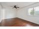 Bright bedroom with hardwood floors, white walls, and a ceiling fan with natural light from a window at 12037 E Harvard Ave # 104, Aurora, CO 80014