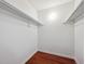 Empty walk-in closet with laminate flooring and white walls and shelving at 12037 E Harvard Ave # 104, Aurora, CO 80014