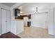 Bright kitchen and dining area featuring neutral tile and dark cabinets at 12037 E Harvard Ave # 104, Aurora, CO 80014