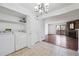 Laundry area leading to a spacious living room with a brick fireplace at 12037 E Harvard Ave # 104, Aurora, CO 80014