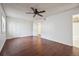 Spacious primary bedroom with a ceiling fan, two closets, and laminate floors at 12037 E Harvard Ave # 104, Aurora, CO 80014